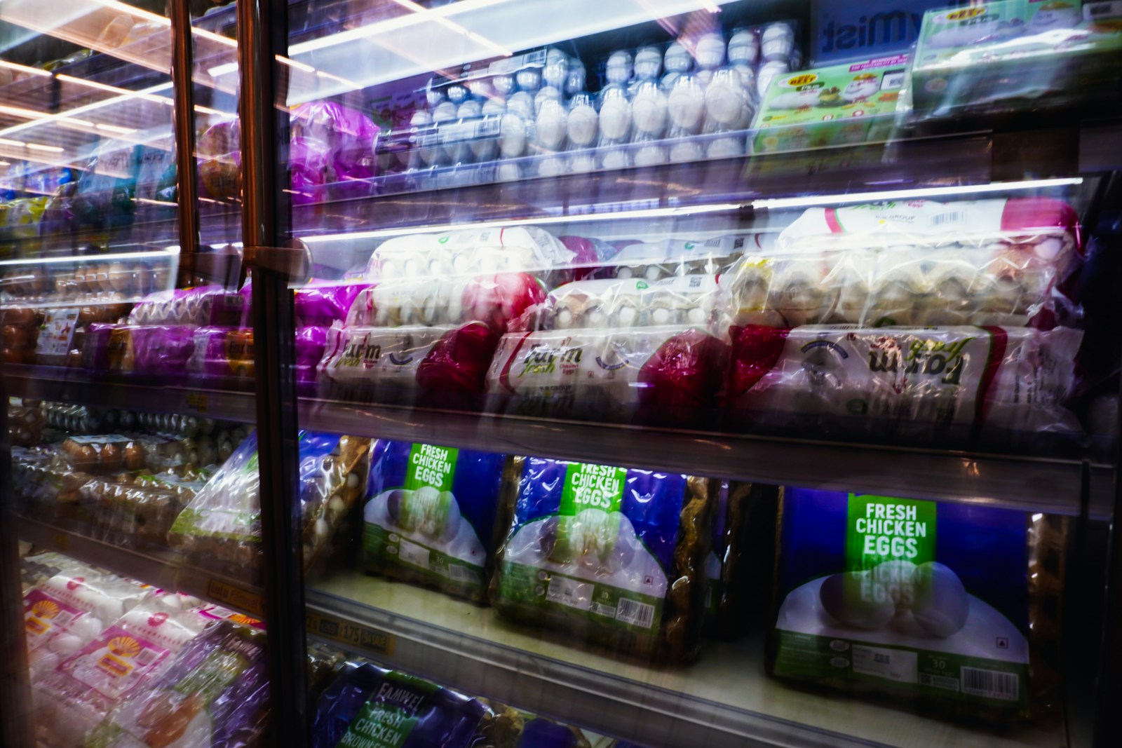 Packaged food products displayed in a refrigerated grocery store case
